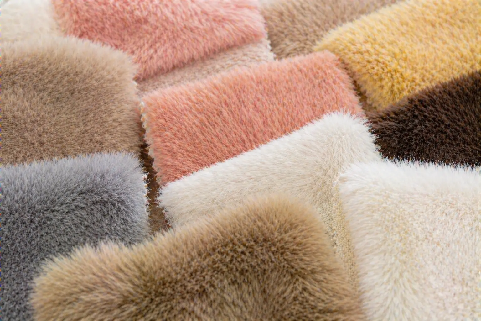 Close-up fabric swatches showing plush pile heights, textures, and color variations for plush toy development